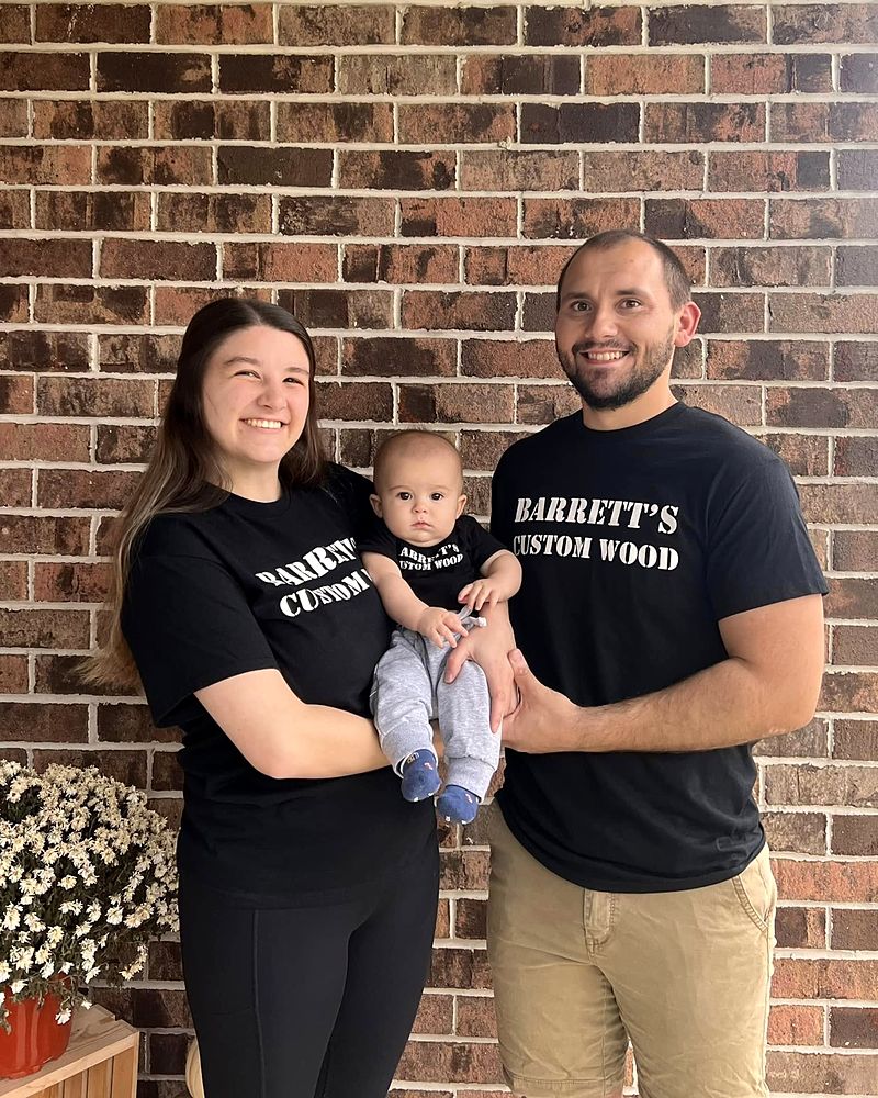 RJ and Alexa with their baby, wearing Barrett's Custom Wood shirts