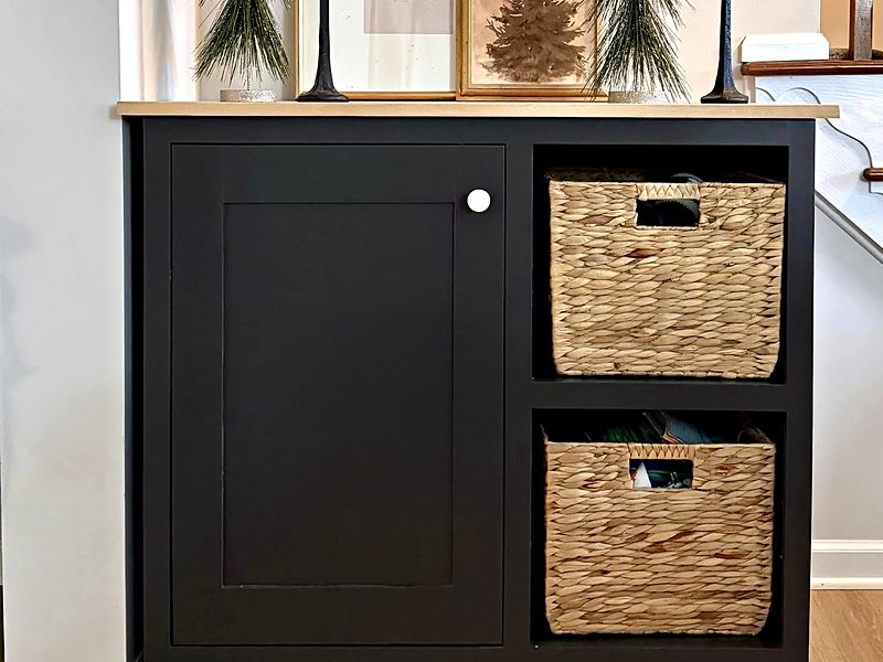 Black built-in cabinet with woven basket cubbies