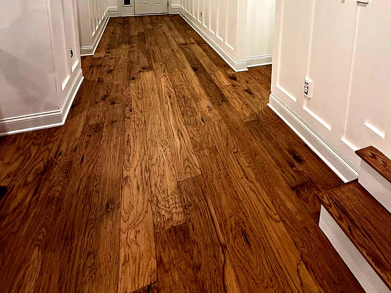 Hand-scraped hardwood floor running down an entry hall