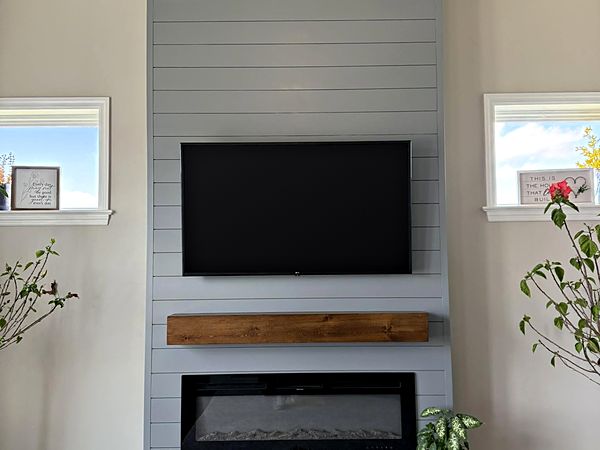 Shiplap fireplace wall with wood mantel